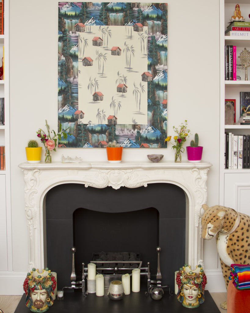 A painting by Neil Raitt hangs above the fireplace in Noor Fares' home