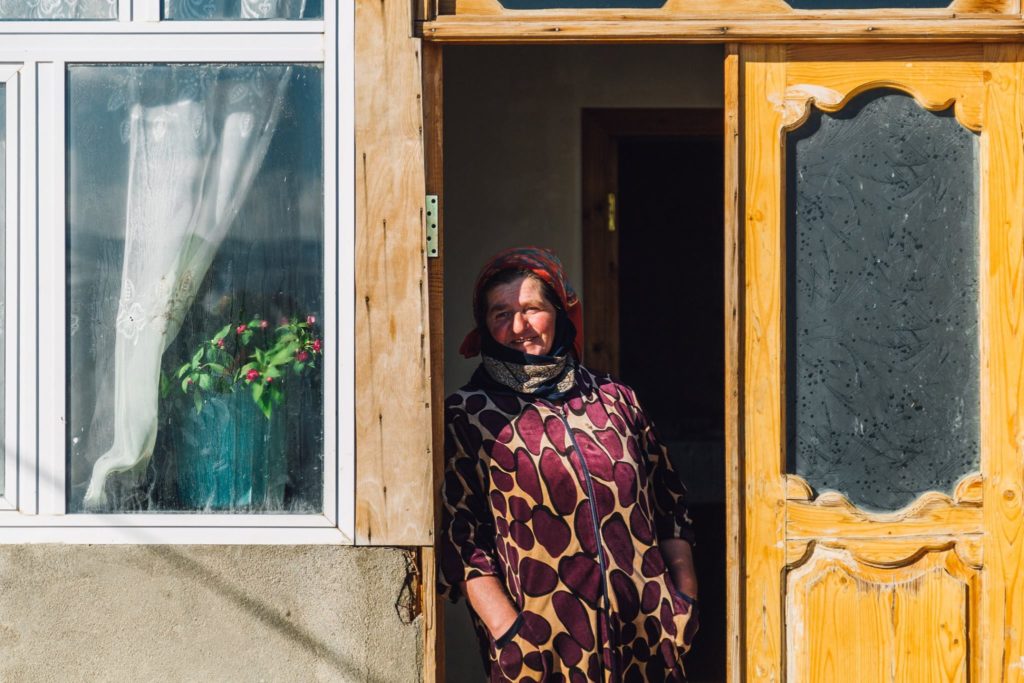 A woman in Azerbaijan standing by the door to her house in Baku