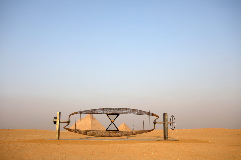 A sculpture in the desert in front of 