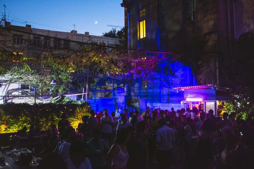 people at a party outside with purple lights