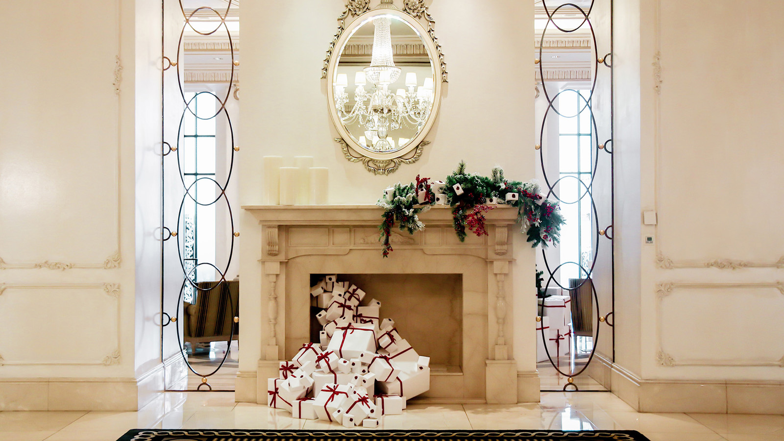 A fireplace with wrapped presents coming out of the fireplace