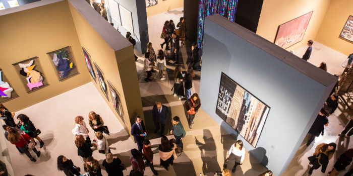 bird's eye view of people walking around an art gallery