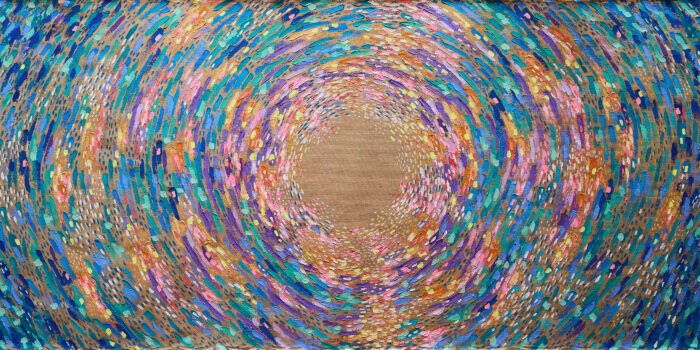 A spiral of colourful paints decorating a brown canvas