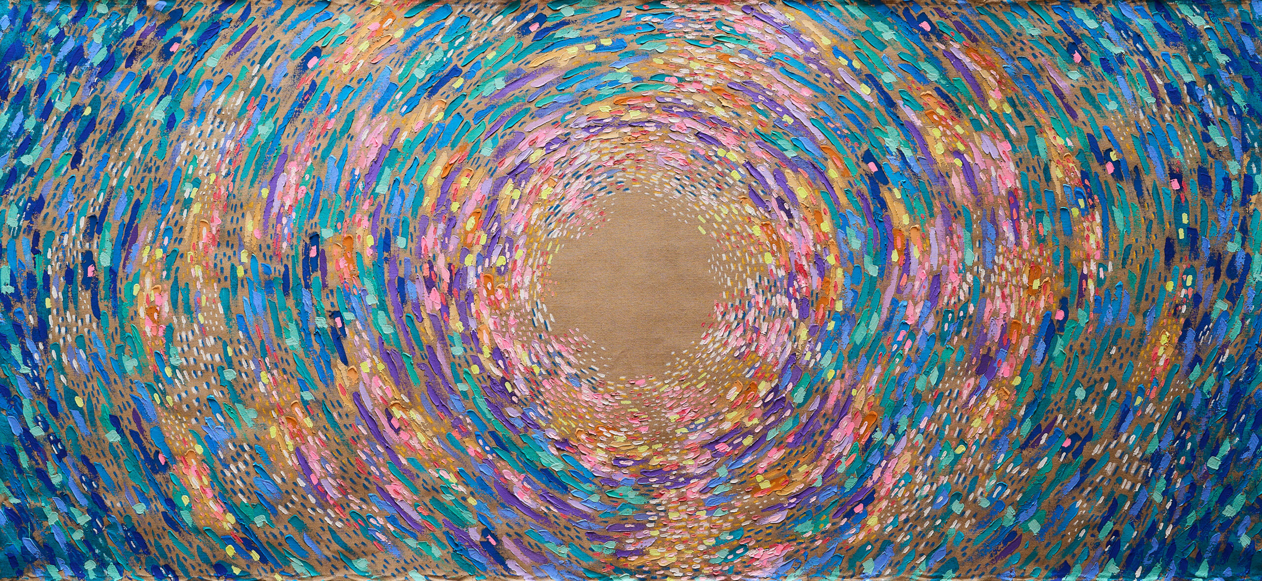 A spiral of colourful paints decorating a brown canvas