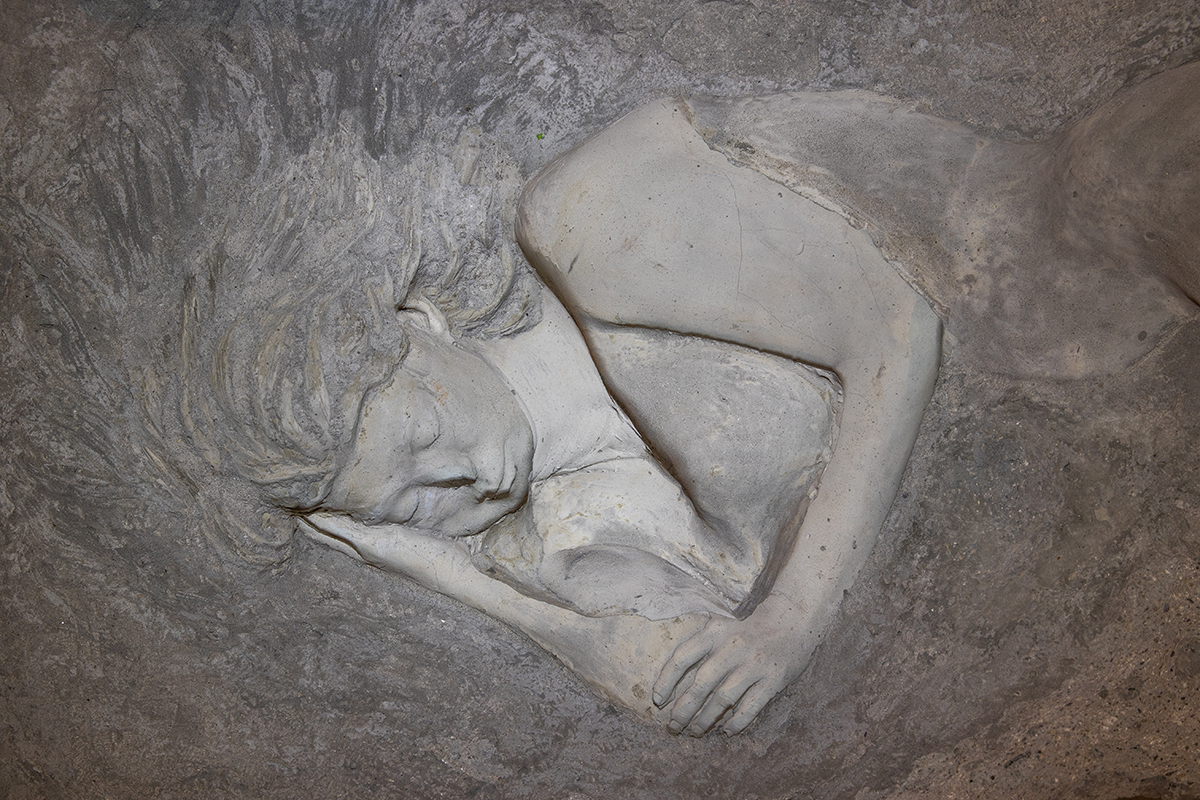 A woman carved into grey stone