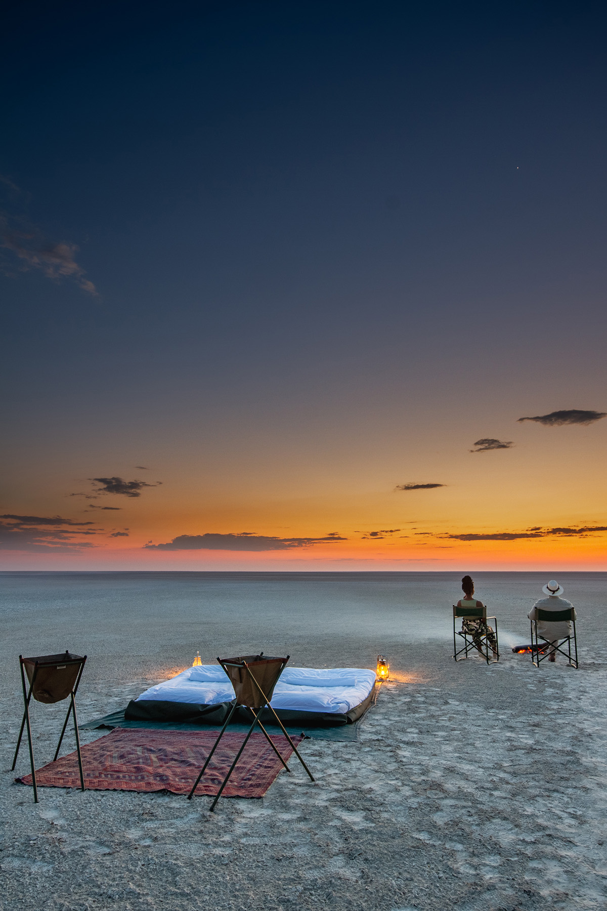 Sleeping set up on sandy beach at sunset